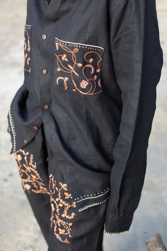 Black linen shirt with intricate orange embroidery on pockets