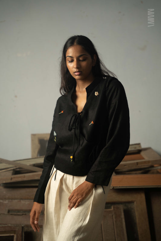 Close-up of embroidered flowers on 60 lea linen fabric in black color