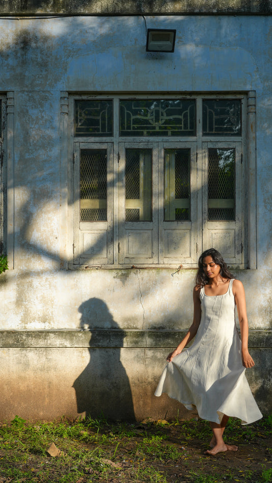 Mariya wearing off-white ankle-length linen dress with vertical panels