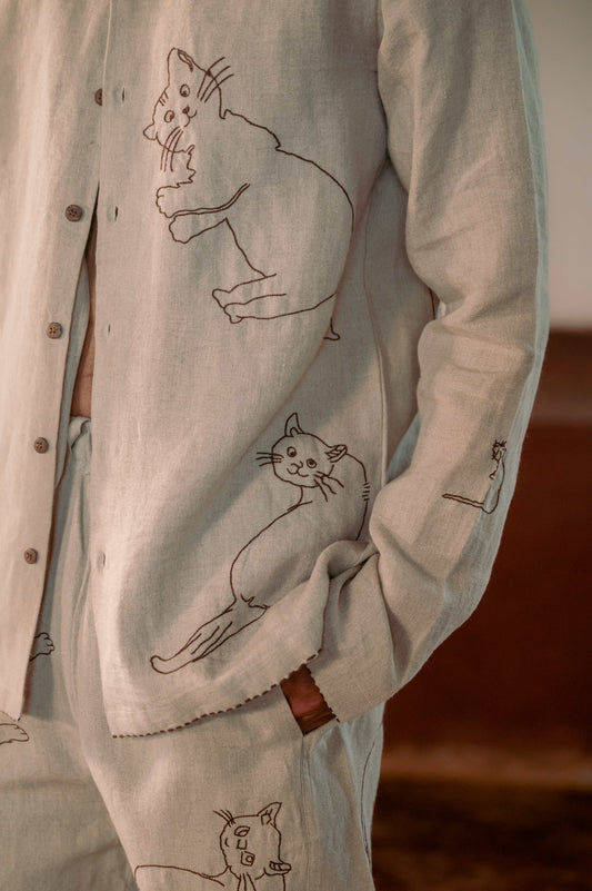 Front detail of a beige full sleeved linen shirt with hand-embroidered cats