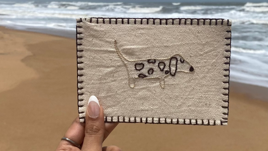 Hand-embroidered postcard featuring a playful dog design, crafted from sustainable linen, ideal for dog lovers