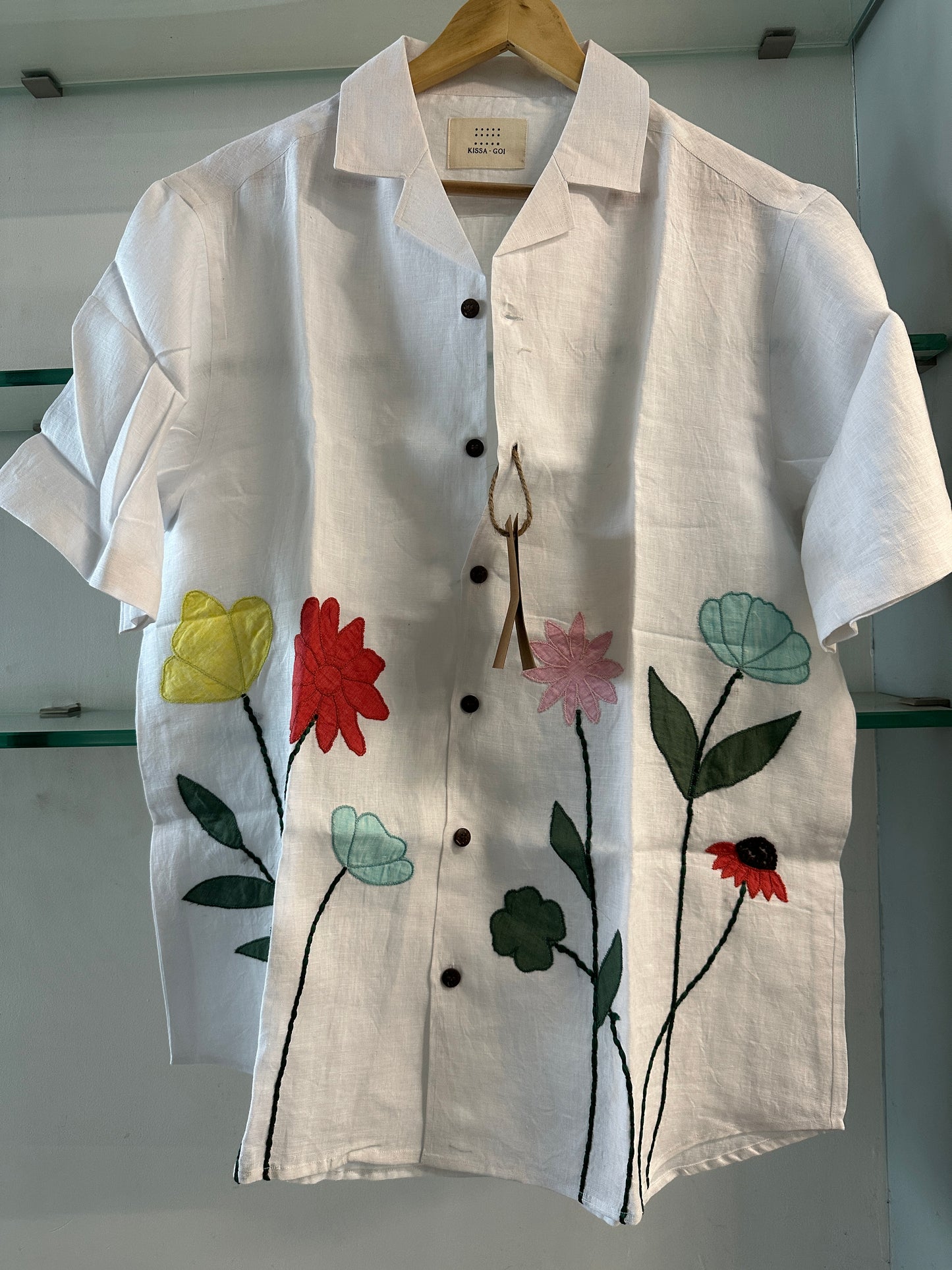 patchwork of flowers on a offwhite linen shirt