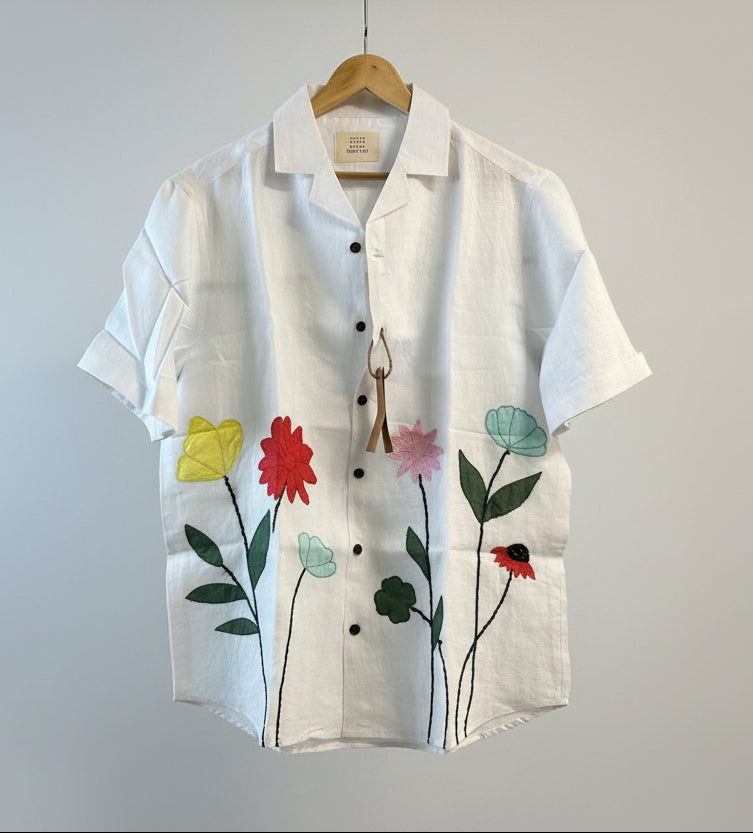 patchwork of flowers on a offwhite linen shirt