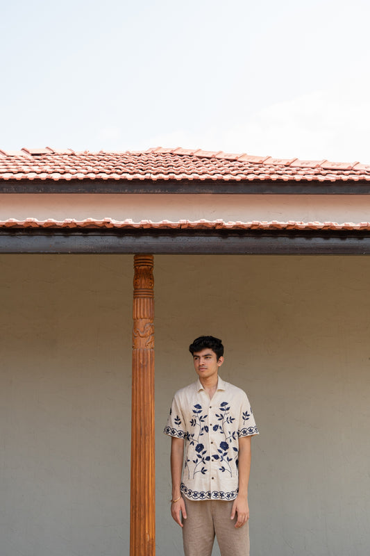 Soham wearing a off-white linen shirt with hand embroidered floral and vines pattern