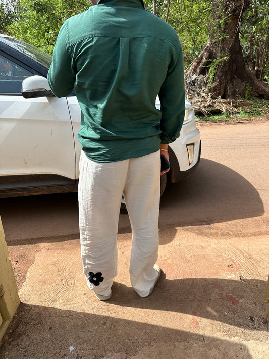 Back of off-white cotton lounge pants with a flower embroidery