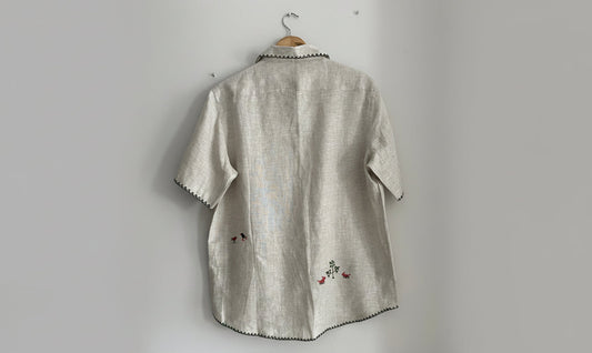 beige fabric with forest embroidery on a white background