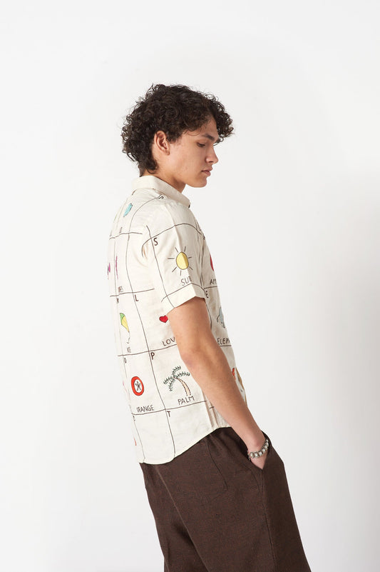Side view of an offwhite cotton shirt with the hand-embroidered alphabet A to Z