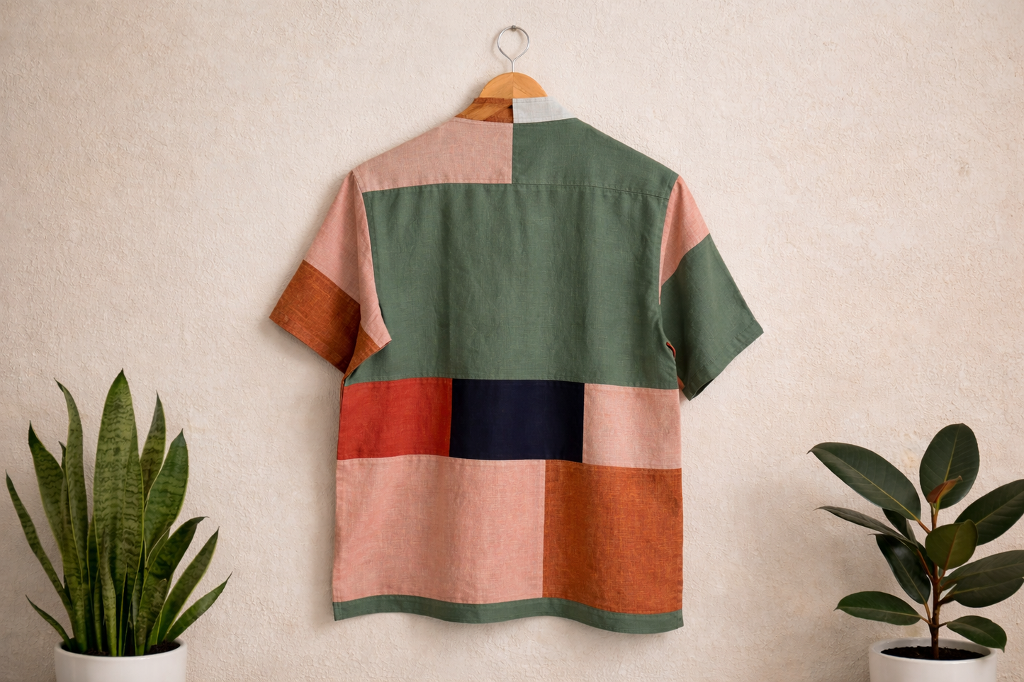 Back of patchwork linen shirt displayed against a white wall