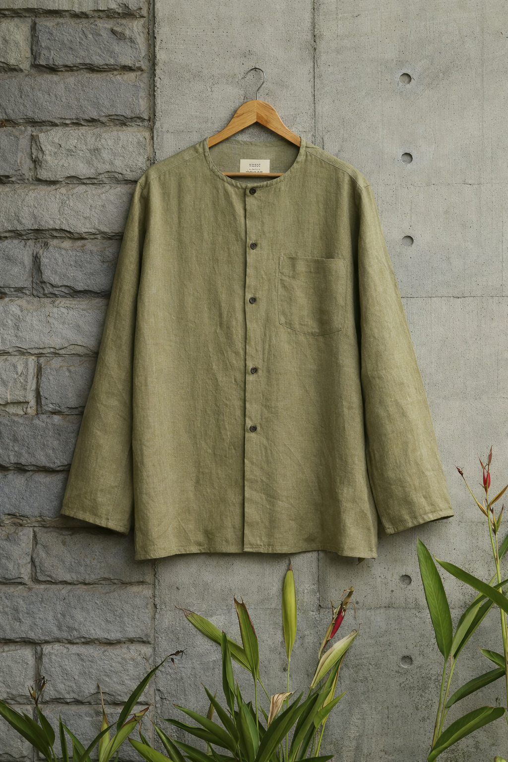 Mustard Green Collarless Linen shirt displayed against a grey wall