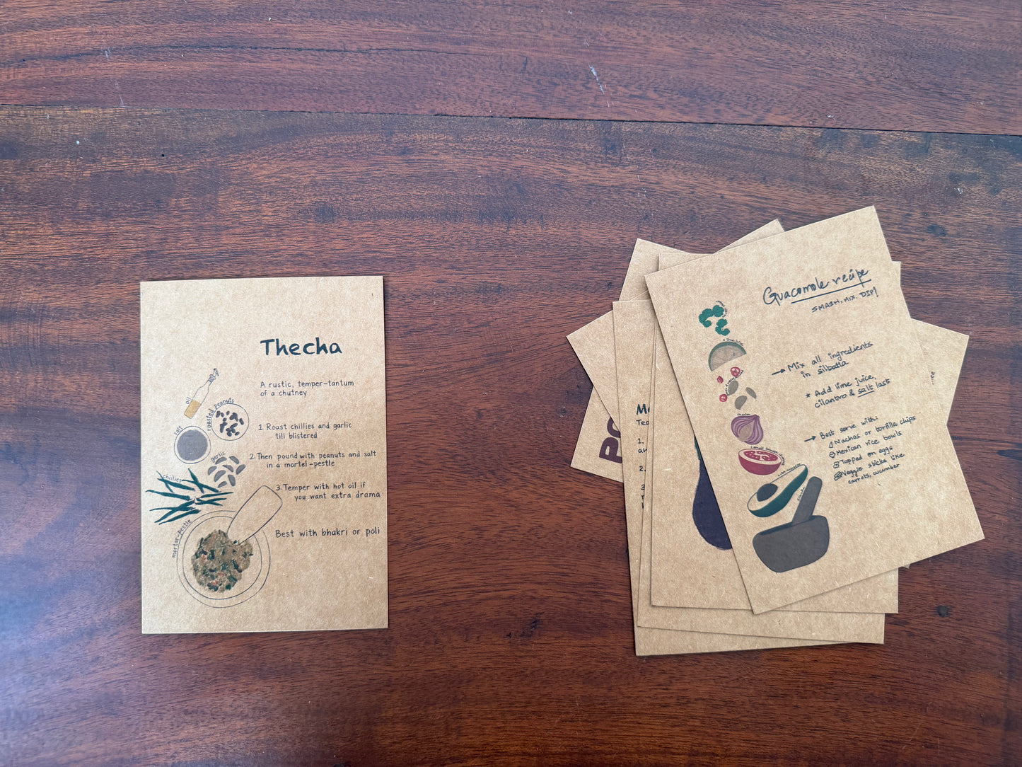 Set of recipe postcards on a wooden surface