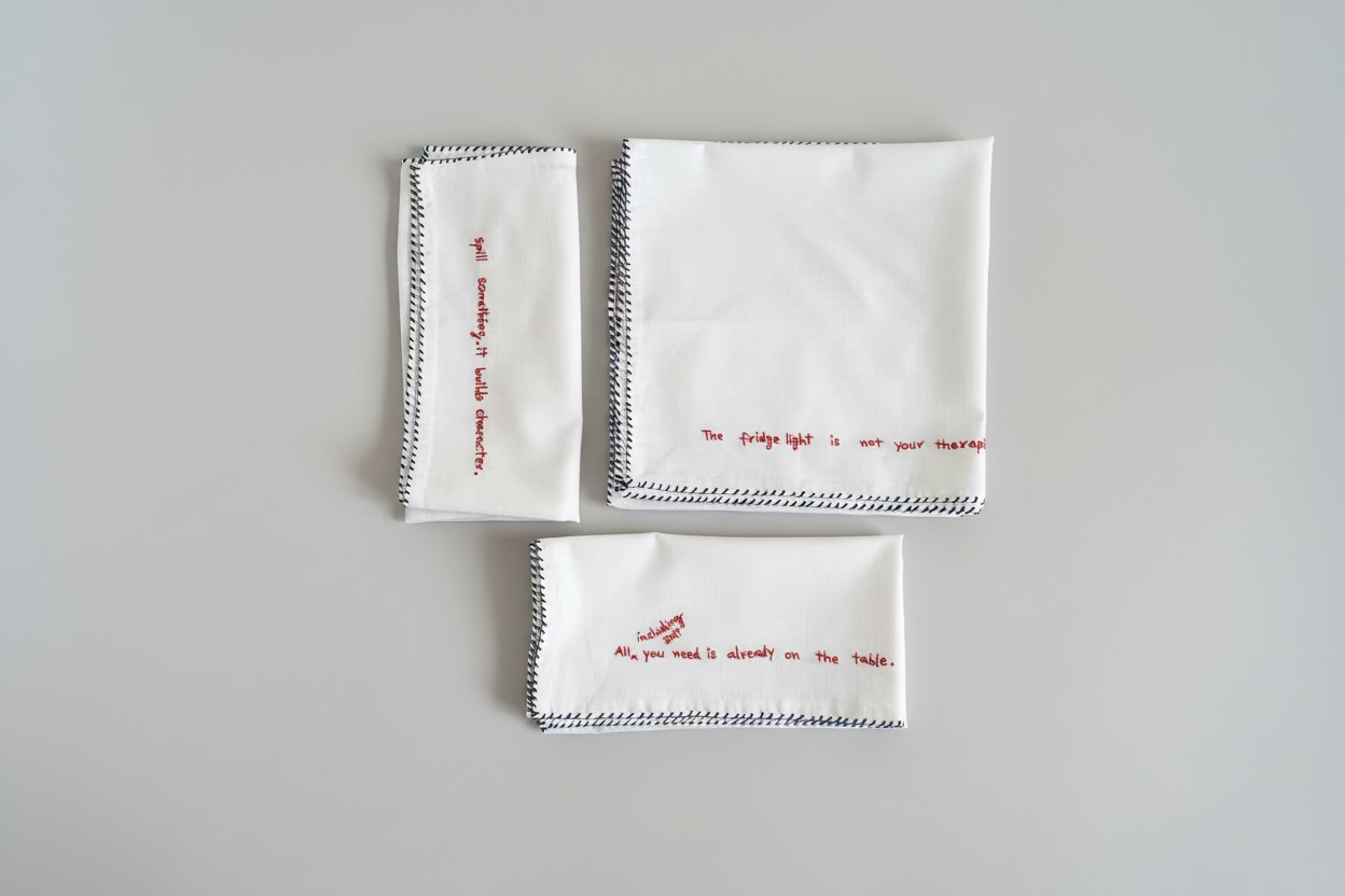 Three white embroidered napkins